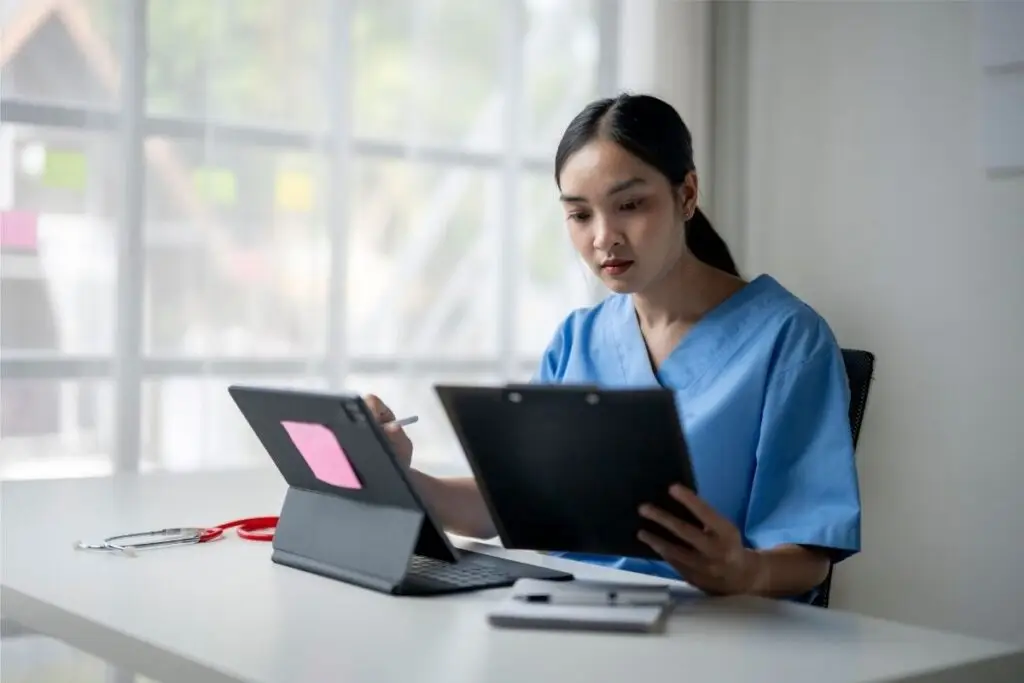 Female doctor studying at her desk for the MRCEM exam