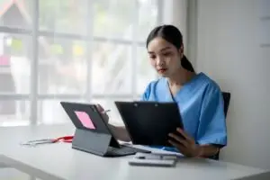 Free Articles 8 Female doctor studying at her desk for the MRCEM exam